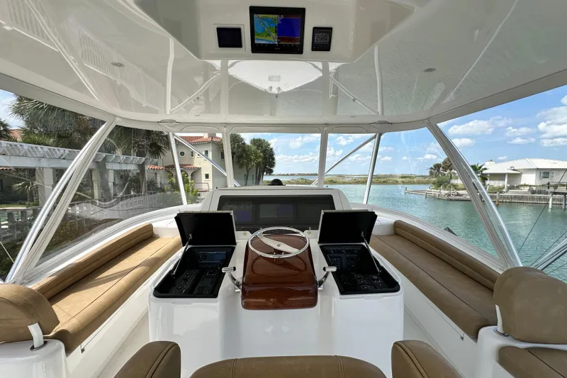 Wildcatter Yacht Photos Pics Interior view of 2017 Viking 55 Convertible yacht helm with navigation screens and seating.