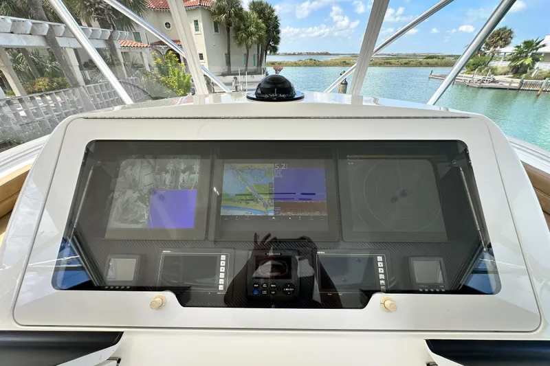 Wildcatter Yacht Photos Pics Cockpit dashboard of 2017 Viking 55 Convertible yacht with navigation screens.
