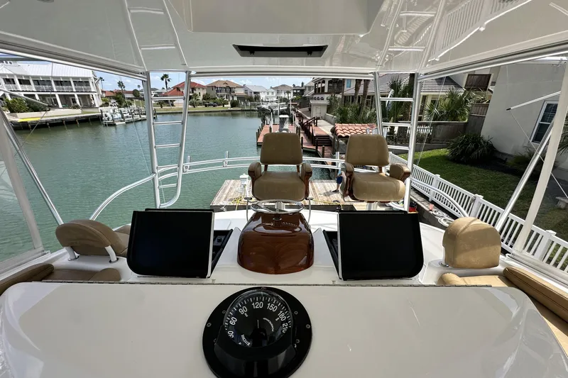 Wildcatter Yacht Photos Pics 2017 Viking 55 Convertible yacht helm with dual seats and navigation equipment.