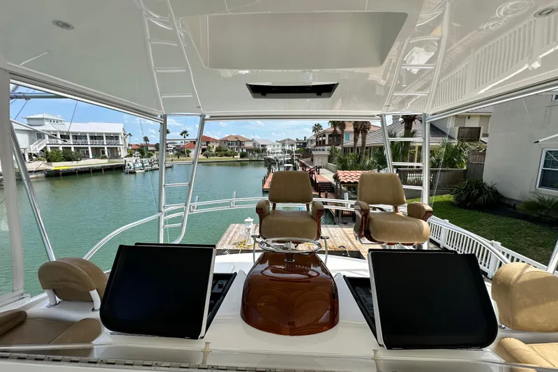 Wildcatter Yacht Photos Pics Flybridge of 2017 Viking 55 Convertible yacht with luxurious seating and waterfront view.