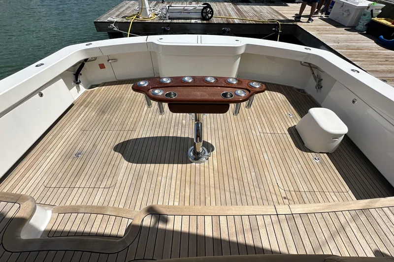 Wildcatter Yacht Photos Pics Spacious deck of 2017 Viking 55 Convertible yacht with wooden flooring and central table.