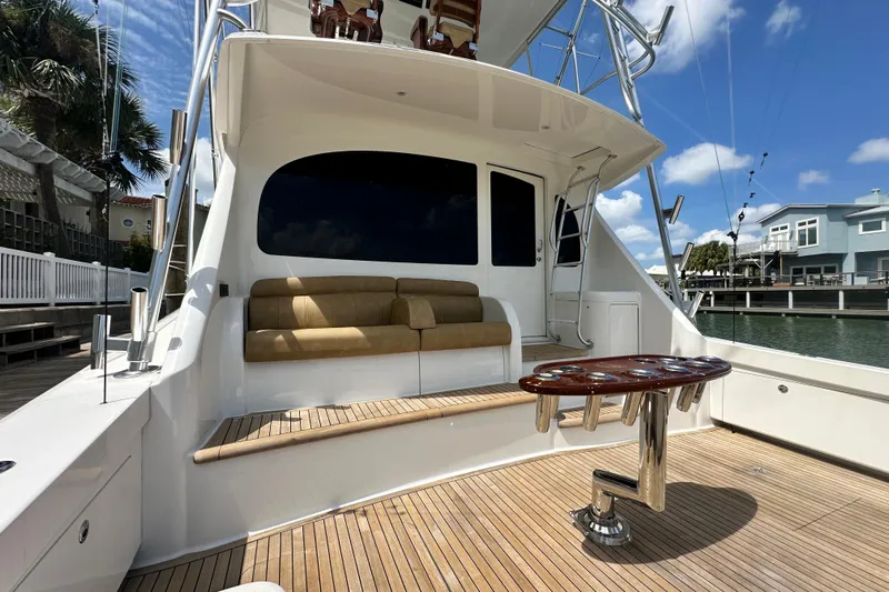 Wildcatter Yacht Photos Pics 2017 Viking 55 Convertible yacht with teak deck, cushioned seating, and fishing rod holders.