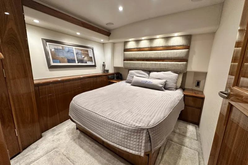 Wildcatter Yacht Photos Pics Luxurious bedroom interior of 2017 Viking 55 Convertible yacht with elegant wood finishes.