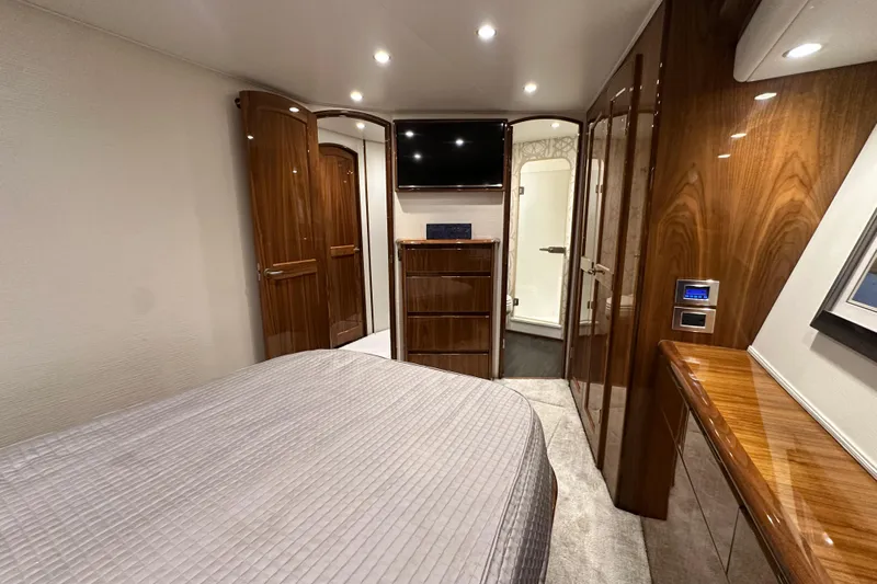 Wildcatter Yacht Photos Pics Luxurious interior of 2017 Viking 55 Convertible yacht bedroom with wood finishes.