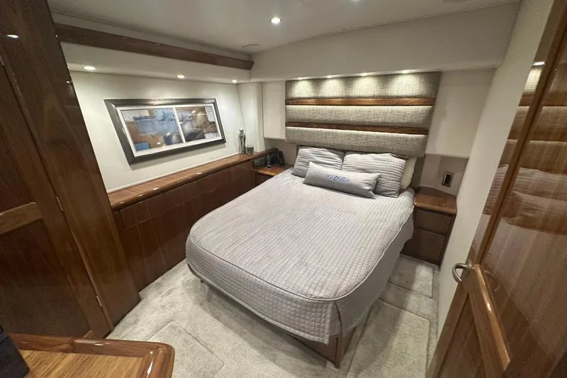 Wildcatter Yacht Photos Pics Luxurious bedroom interior of 2017 Viking 55 Convertible yacht with elegant wood finishes.