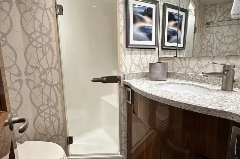 Wildcatter Yacht Photos Pics Luxurious bathroom in 2017 Viking 55 Convertible yacht with modern fixtures and elegant decor.