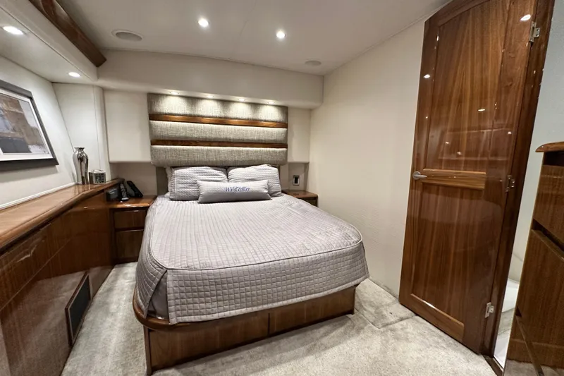 Wildcatter Yacht Photos Pics Luxurious bedroom interior of 2017 Viking 55 Convertible yacht with elegant wood finishes.