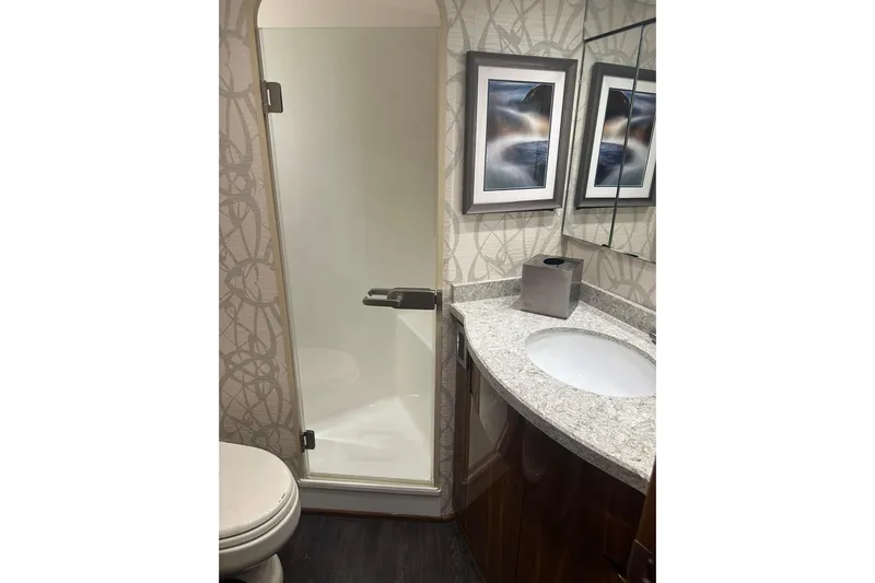 Wildcatter Yacht Photos Pics Bathroom interior of 2017 Viking 55 Convertible yacht with shower and modern decor.