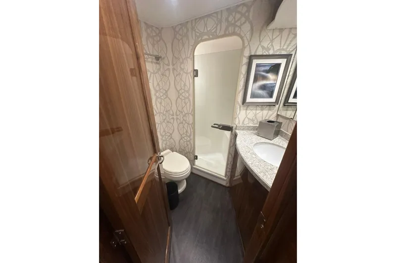 Wildcatter Yacht Photos Pics Luxurious bathroom in 2017 Viking 55 Convertible yacht with modern fixtures and elegant design.