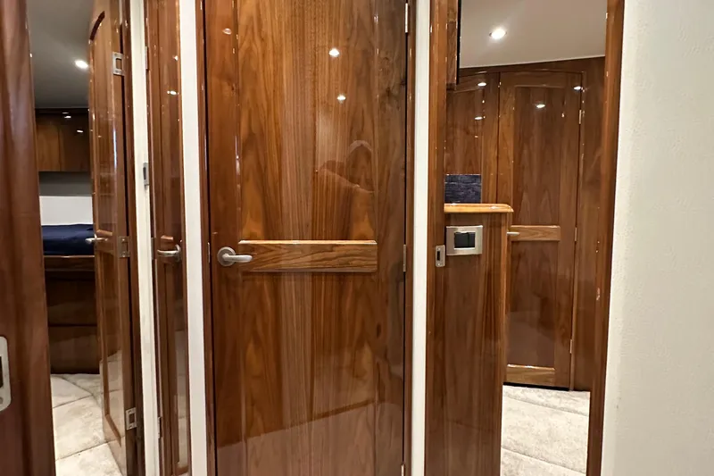 Wildcatter Yacht Photos Pics Luxurious wooden interior of 2017 Viking 55 Convertible yacht, featuring elegant doors and modern design.