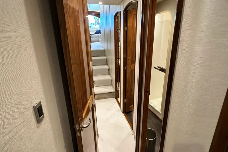 Wildcatter Yacht Photos Pics Interior hallway of 2017 Viking 55 Convertible yacht with wooden doors and stairs.