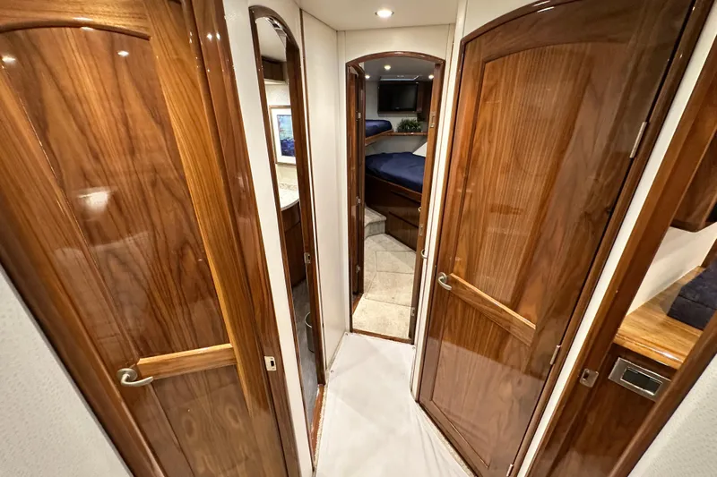Wildcatter Yacht Photos Pics Interior hallway of 2017 Viking 55 Convertible yacht with wooden doors and cozy cabin.