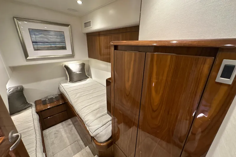Wildcatter Yacht Photos Pics Luxurious cabin interior of 2017 Viking 55 Convertible yacht with twin beds and elegant wood finish.