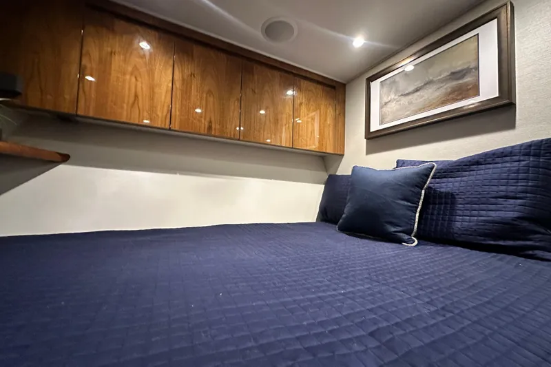 Wildcatter Yacht Photos Pics Luxurious cabin interior of 2017 Viking 55 Convertible yacht with navy bedding.