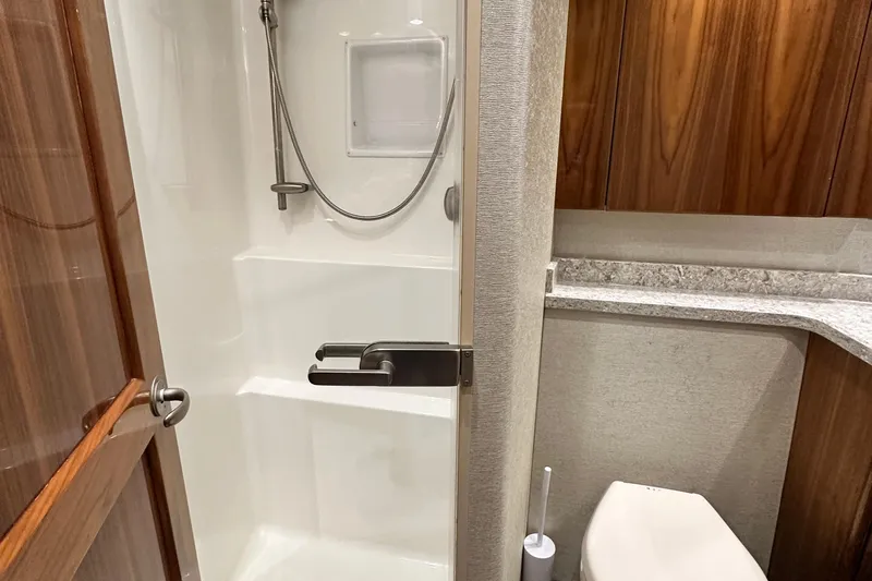 Wildcatter Yacht Photos Pics Luxurious bathroom in 2017 Viking 55 Convertible yacht with shower and modern fixtures.