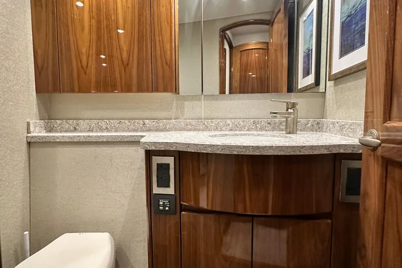 Wildcatter Yacht Photos Pics Luxurious bathroom in 2017 Viking 55 Convertible yacht with wood cabinetry and modern fixtures.