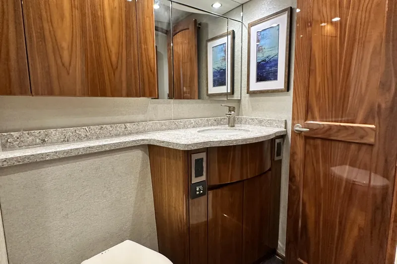 Wildcatter Yacht Photos Pics Luxurious bathroom interior of 2017 Viking 55 Convertible yacht with wood cabinetry and modern fixtures.