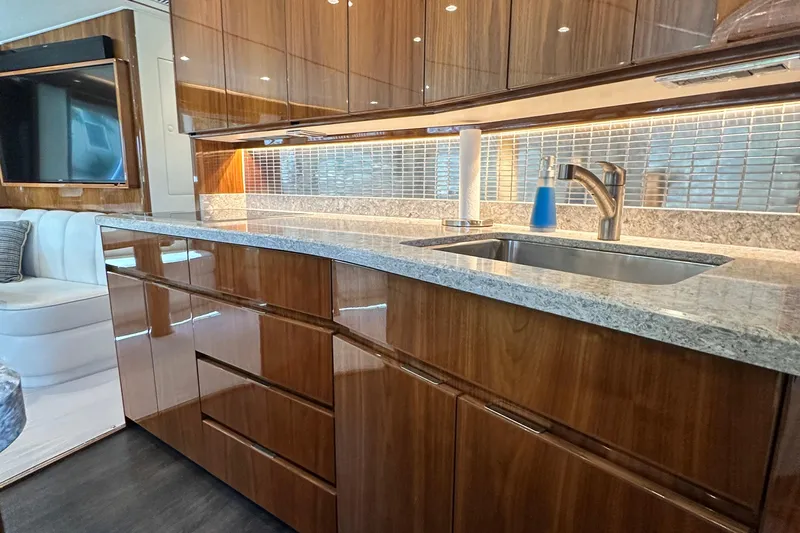 Wildcatter Yacht Photos Pics Luxurious kitchen interior of 2017 Viking 55 Convertible yacht with sleek cabinetry and modern fixtures.