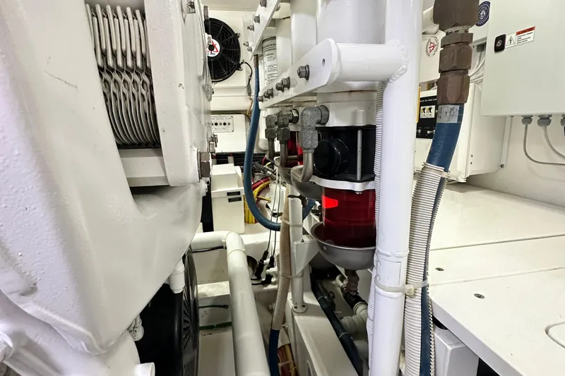 Wildcatter Yacht Photos Pics Engine room of 2017 Viking 55 Convertible yacht, showcasing mechanical components and piping.
