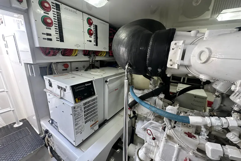 Wildcatter Yacht Photos Pics Engine room of 2017 Viking 55 Convertible with Cummins Onan generator and control panels.