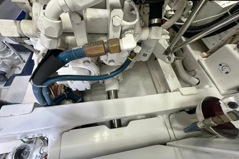 Wildcatter Yacht Photos Pics Engine room of 2017 Viking 55 Convertible yacht, showcasing mechanical components and hoses.