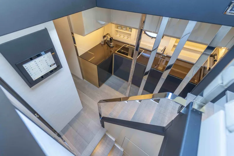 M Yacht Photos Pics Modern interior of 2018 Pershing 70 yacht with sleek kitchen and staircase.