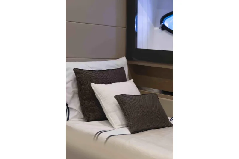 M Yacht Photos Pics Luxurious interior of 2018 Pershing 70 yacht with elegant cushions and window view.