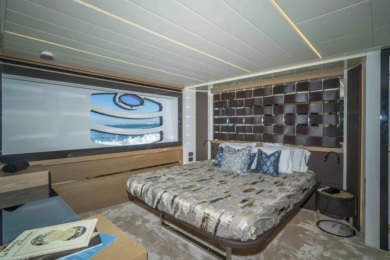M Yacht Photos Pics Luxurious bedroom interior of 2018 Pershing 70 yacht with modern design and ocean view.