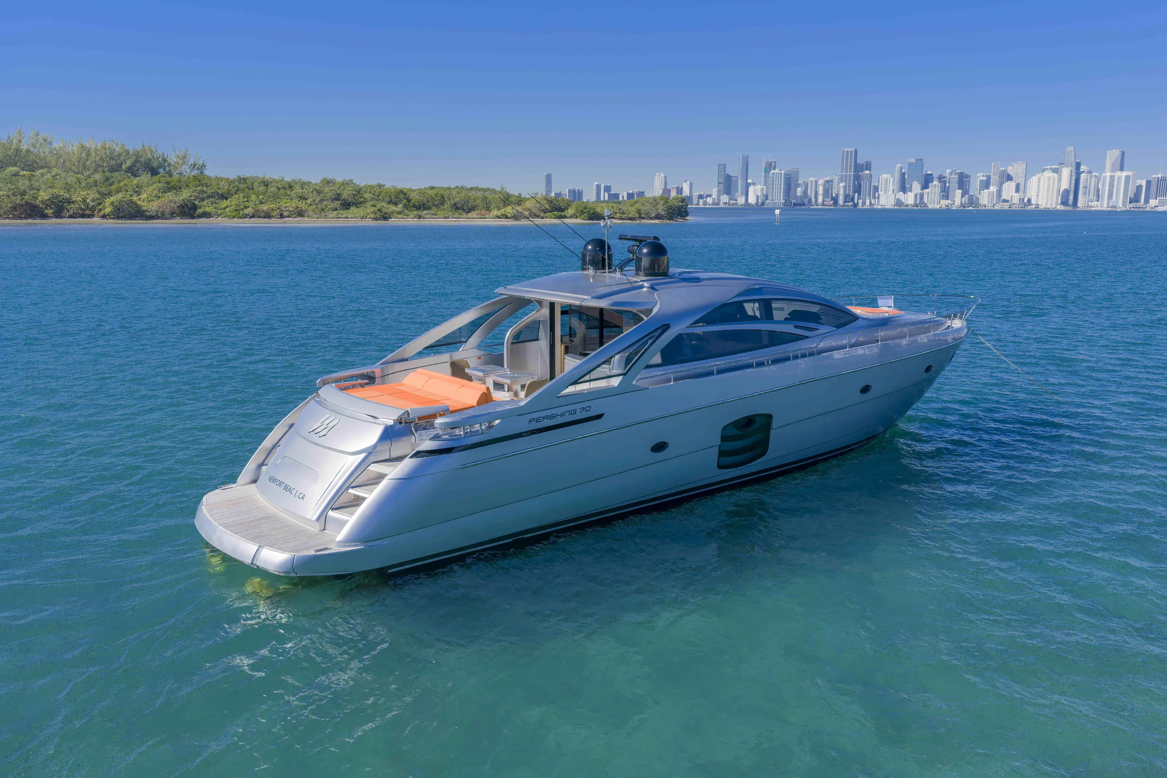 M Yacht Photos Pics 2018 Pershing 70 yacht on blue water with city skyline in background.
