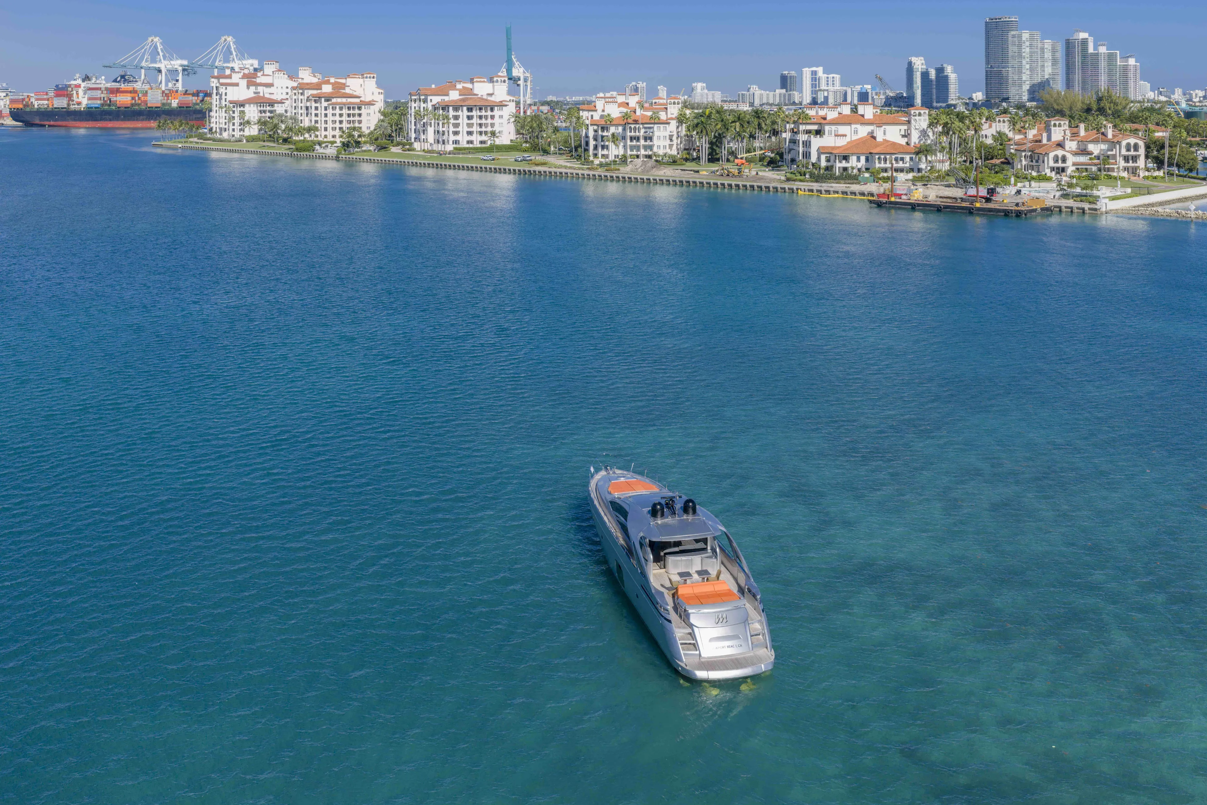 M Yacht Photos Pics 2018 Pershing 70 yacht cruising near coastal city skyline.