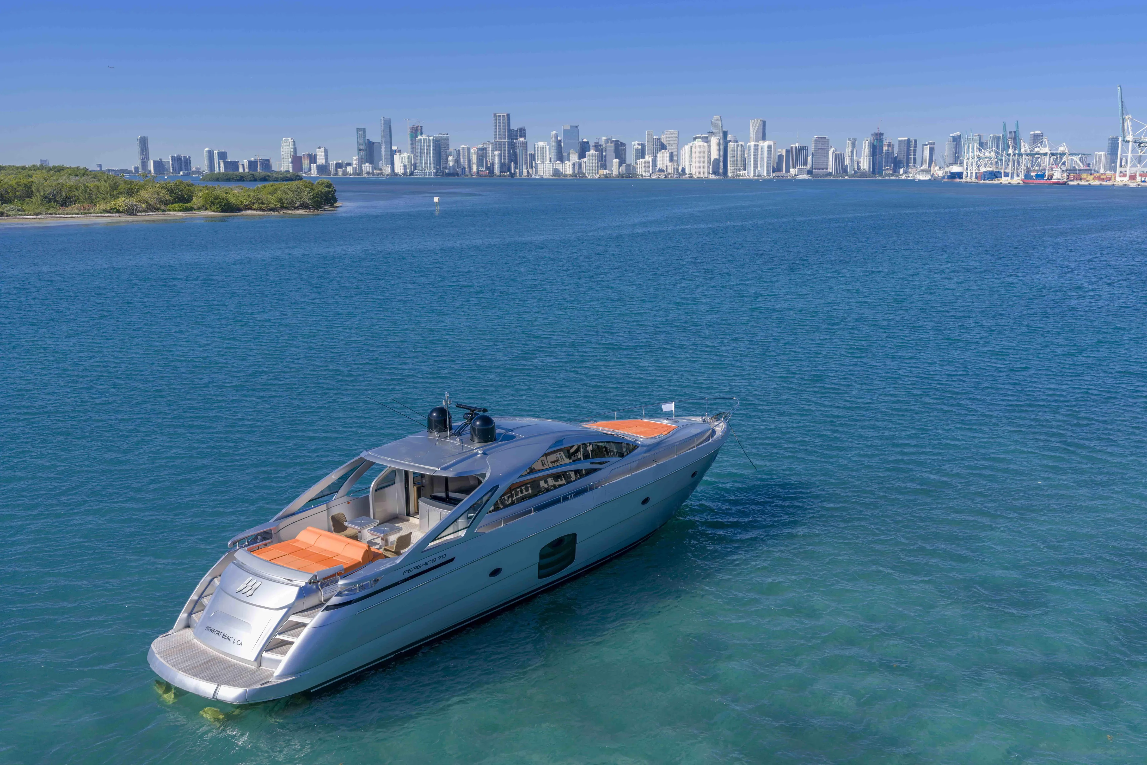 M Yacht Photos Pics 2018 Pershing 70 yacht on blue water with city skyline in background.