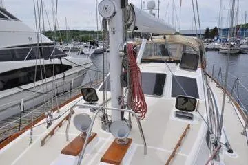 Dragonfly 1 Yacht Photos Pics 2005 Tartan 4400 sailboat docked at marina, showcasing deck and mast.