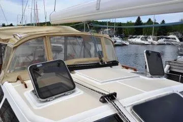 Dragonfly 1 Yacht Photos Pics 2005 Tartan 4400 sailboat docked at marina with open hatches.