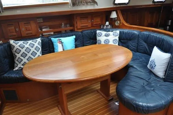 Dragonfly 1 Yacht Photos Pics Luxurious Tartan 4400 yacht interior with wooden table and cushioned seating, 2005 model.