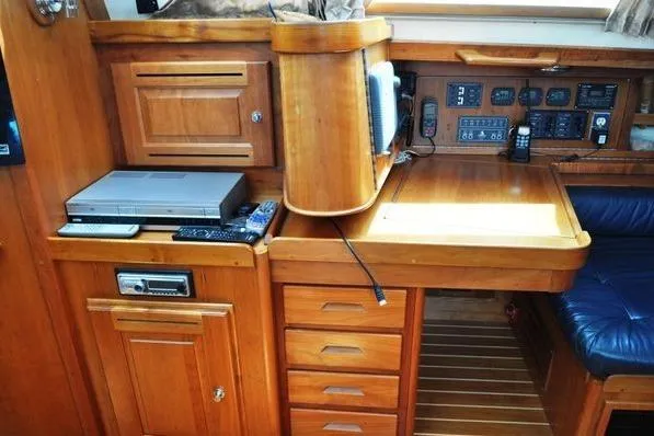 Dragonfly 1 Yacht Photos Pics Navigation station in 2005 Tartan 4400 yacht with wooden cabinetry and electronic equipment.