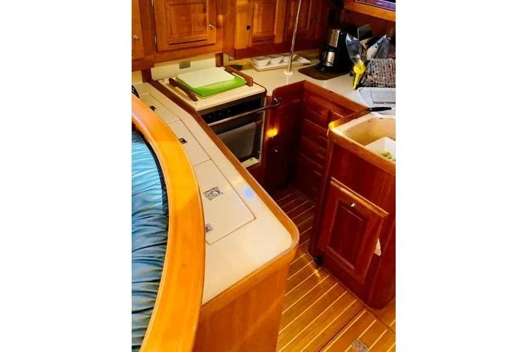 Dragonfly 1 Yacht Photos Pics Luxurious 2005 Tartan 4400 yacht interior with wooden cabinetry and modern kitchen amenities.