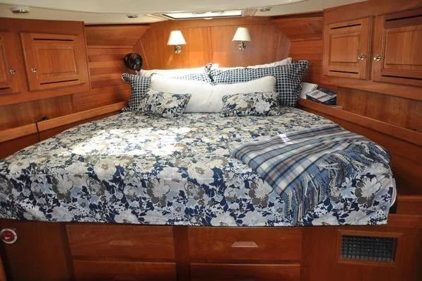 Dragonfly 1 Yacht Photos Pics Luxurious 2005 Tartan 4400 yacht cabin with floral bedding and wooden interior.