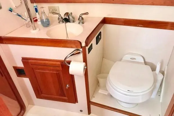 Dragonfly 1 Yacht Photos Pics Compact bathroom in 2005 Tartan 4400 yacht with sink and toilet.