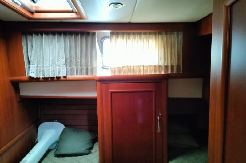 Sesaccia Yacht Photos Pics Interior cabin of 2007 Grand Banks 47 Europa yacht with wooden finish and window curtains.