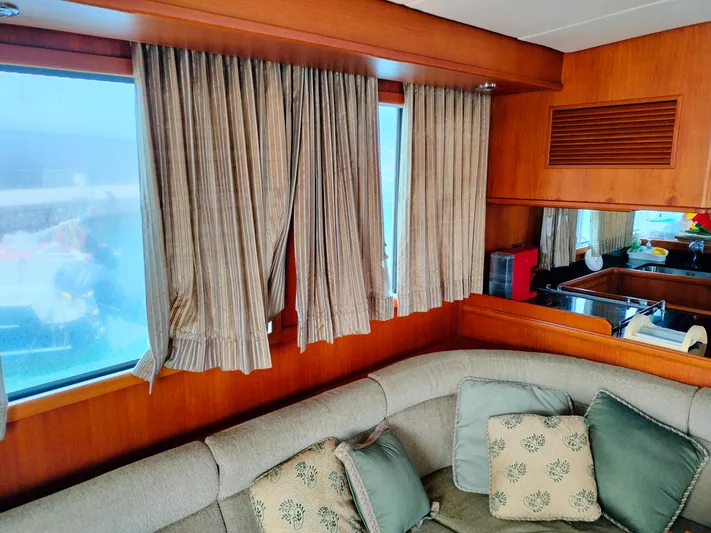 Sesaccia Yacht Photos Pics Interior of 2007 Grand Banks 47 Europa yacht with cozy seating and elegant curtains.