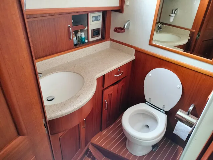 Sesaccia Yacht Photos Pics Bathroom interior of 2007 Grand Banks 47 Europa yacht with wooden cabinetry and modern fixtures.