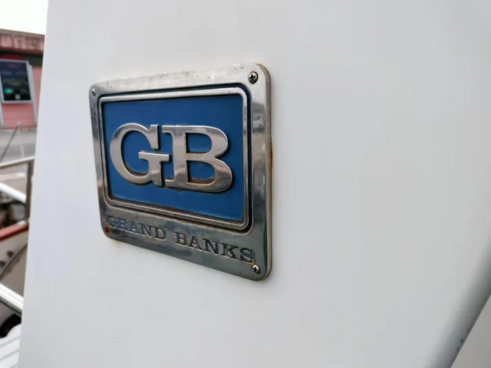 Sesaccia Yacht Photos Pics Grand Banks 47 Europa 2007 emblem on boat exterior.