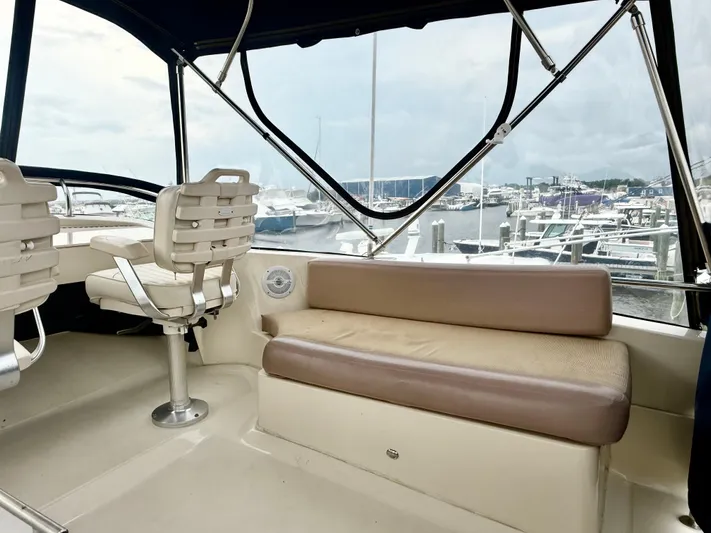  Yacht Photos Pics 2008 Mainship 34 Trawler interior with seating, overlooking marina.