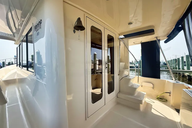  Yacht Photos Pics 2008 Mainship 34 Trawler boat deck with stairs and marina view.