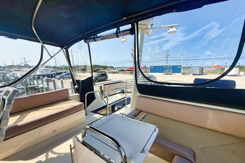  Yacht Photos Pics 2008 Mainship 34 Trawler interior with seating and table, marina view.