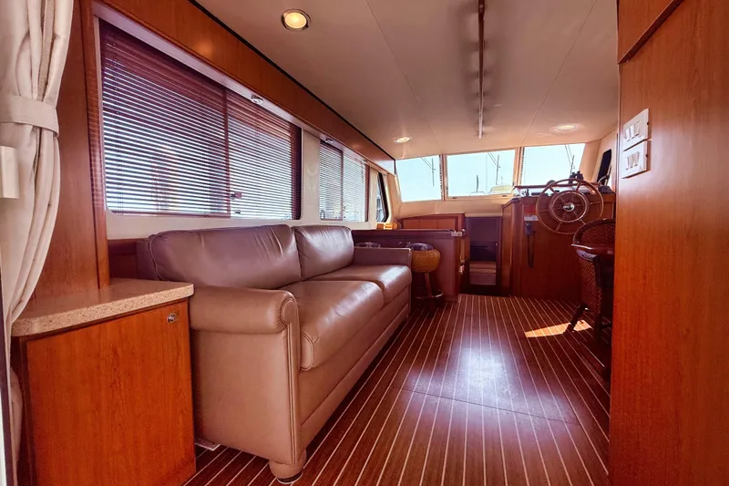  Yacht Photos Pics Interior of 2008 Mainship 34 Trawler with leather sofa and wooden flooring.