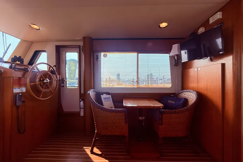  Yacht Photos Pics Interior of 2008 Mainship 34 Trawler with helm, seating, and window view.
