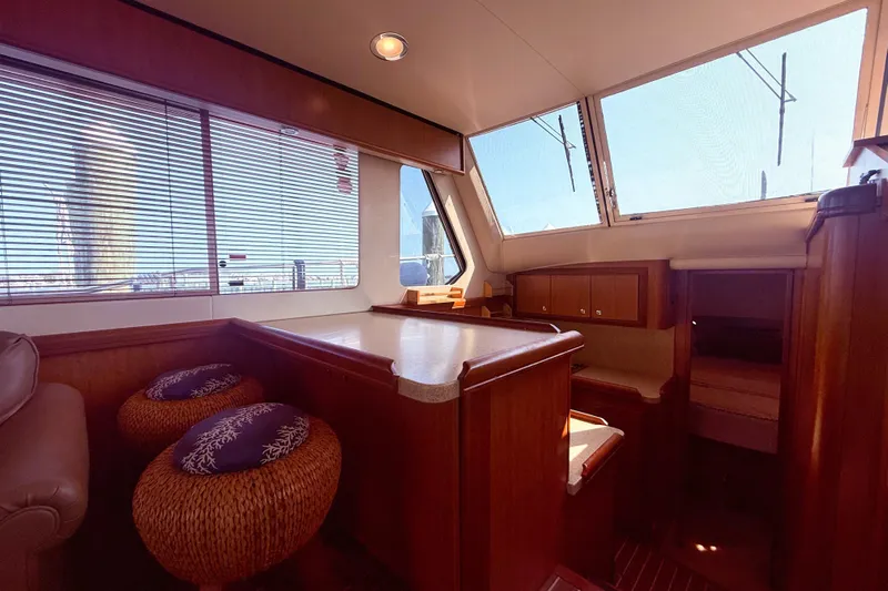  Yacht Photos Pics Interior of 2008 Mainship 34 Trawler with wooden cabinetry and seating area.