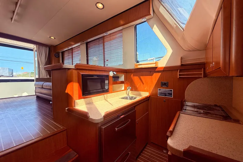  Yacht Photos Pics Interior of 2008 Mainship 34 Trawler, featuring a modern kitchen with wood finishes.