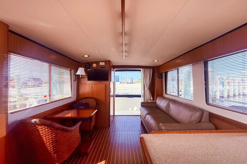  Yacht Photos Pics Interior of 2008 Mainship 34 Trawler with cozy seating and wooden accents.